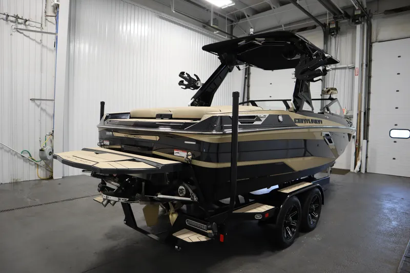 Slide: The Image of 2024 Centurion Ri230 boat in a garage, showcasing sleek design and modern features. - 5