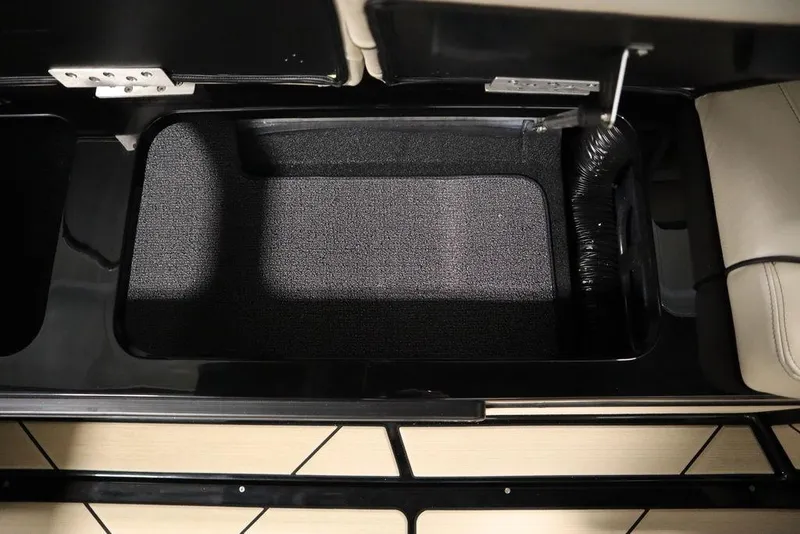 Slide: The Image of 2024 Centurion Ri230 interior storage compartment with black lining and beige seating. - 56