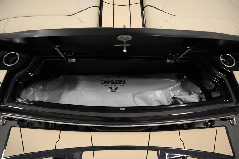 Slide: The Image of 2024 Centurion Ri230 boat storage compartment with black and beige interior detailing. - 70