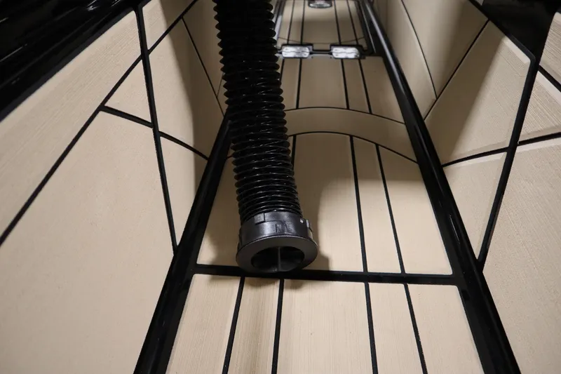 Slide: The Image of 2024 Centurion Ri230 boat storage compartment with ballast bag, open lid view. - 79