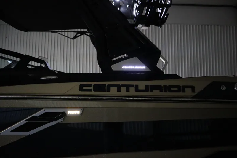 Slide: The Image of 2024 Centurion Ri230 boat on trailer in indoor showroom. - 85