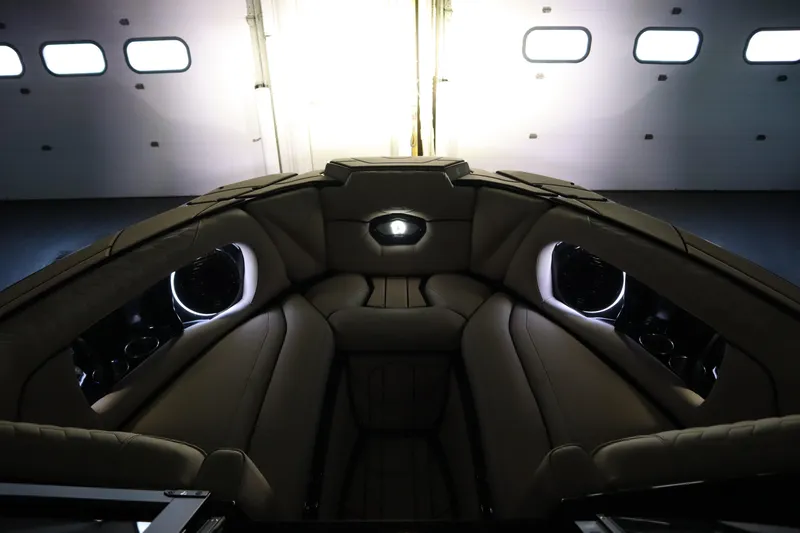 Slide: The Image of 2024 Centurion Ri230 boat in dimly lit indoor setting, showcasing sleek design. - 86