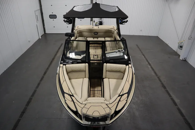Slide: The Image of 2024 Centurion Ri230 boat in a garage, showcasing sleek design and modern features. - 9