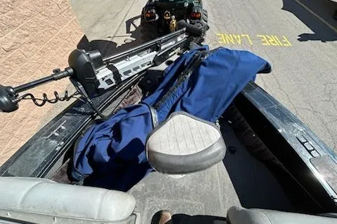 Slide: The Image of 2012 Tracker Targa V-18 WT boat with blue cover and seating, parked near fire lane. - 13