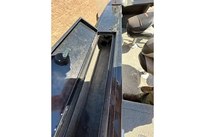 Slide: The Image of 2012 Tracker Targa V-18 WT boat interior with open storage compartment and seating. - 17