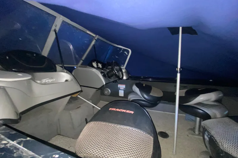 Slide: The Image of Interior of a 2012 Tracker Targa V-18 WT boat with seating and steering console. - 20
