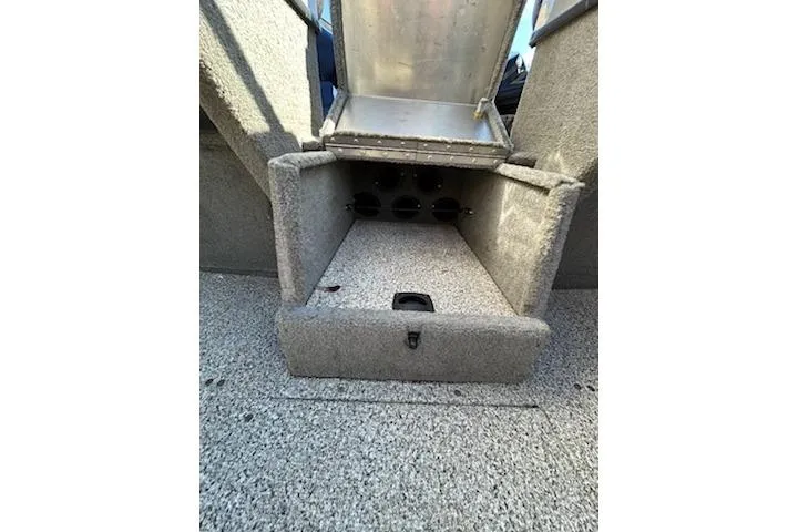 Slide: The Image of 2012 Tracker Targa V-18 WT boat storage compartment with open lid, showcasing interior space. - 5