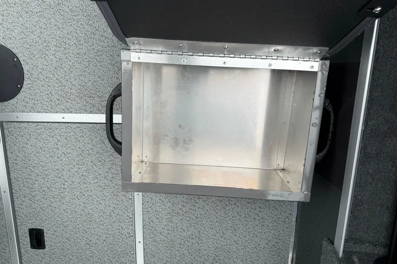 Slide: The Image of Open storage compartment in 2026 Smoker Craft Osprey 172 boat interior. - 16