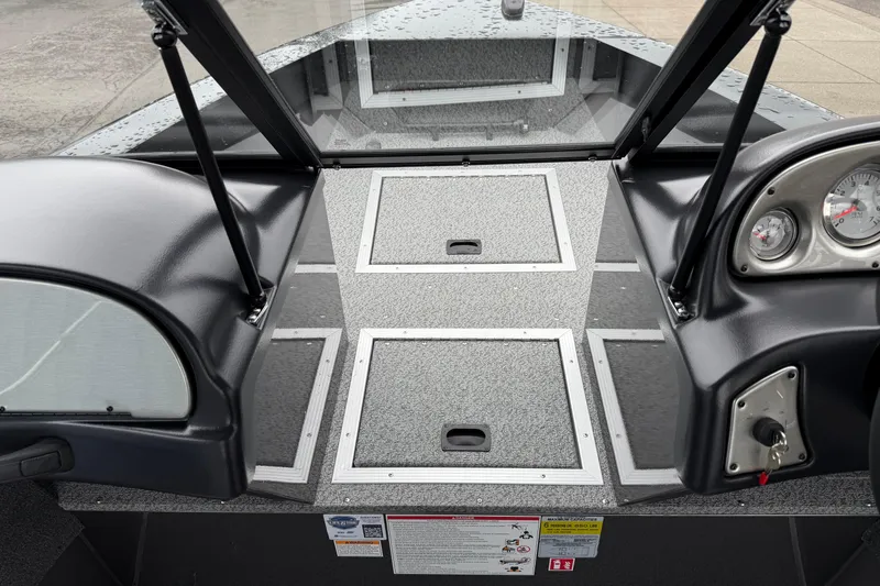 Slide: The Image of 2026 Smoker Craft Osprey 172 boat interior with dashboard and storage compartments. - 17