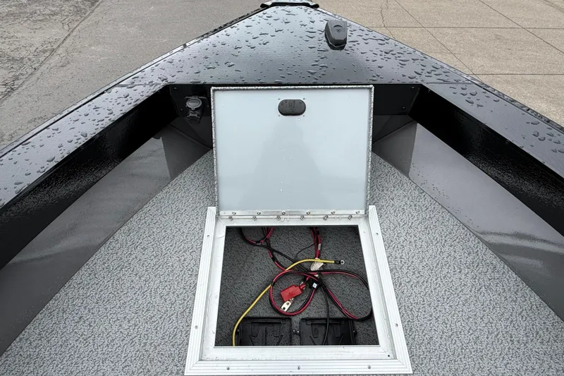 Slide: The Image of 2026 Smoker Craft Osprey 172 boat with open storage compartment and visible wiring. - 23