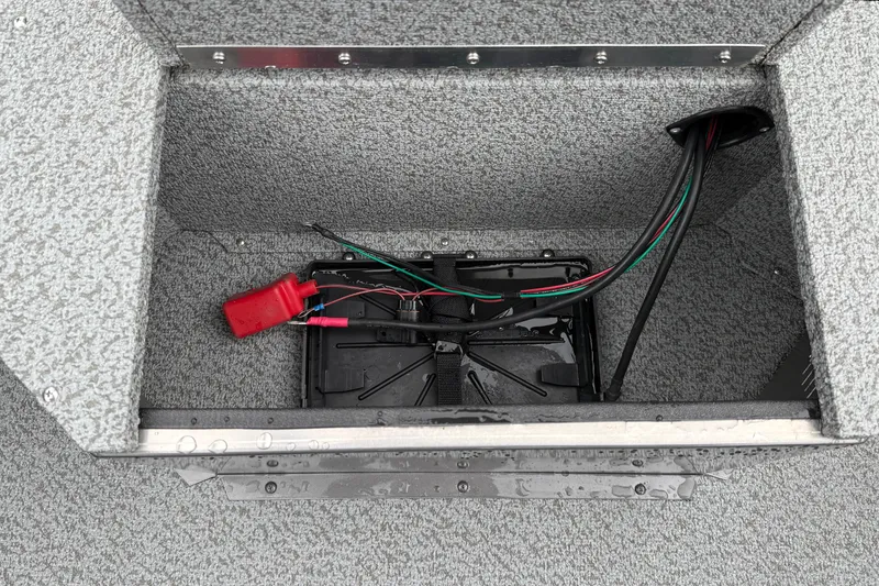 Slide: The Image of Battery compartment of 2026 Smoker Craft Osprey 172 boat with wiring and red connector. - 25