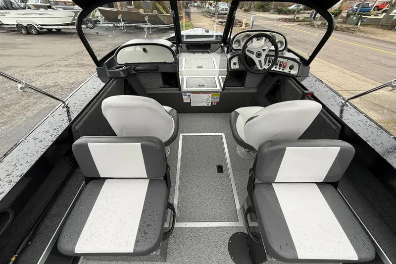 Slide: The Image of 2026 Smoker Craft Osprey 172 boat interior with seating and steering console. - 4