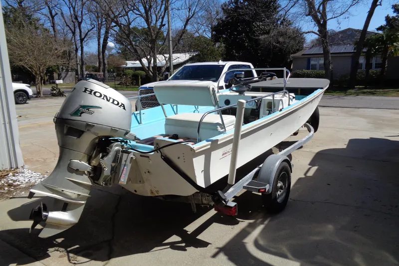 Slide: The Image of 1970 Boston Whaler 17 Montauk boat with Honda outboard motor on trailer. - 14