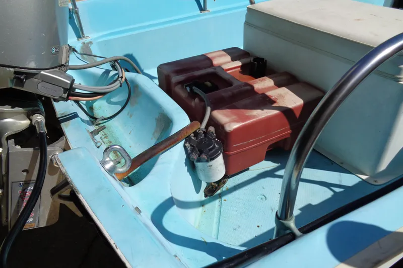 Slide: The Image of 1970 Boston Whaler 17 Montauk interior with fuel tank and engine components. - 18