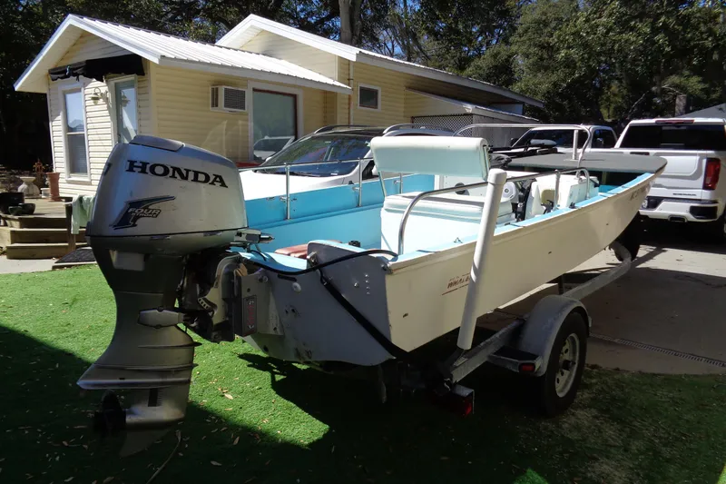 Slide: The Image of 1970 Boston Whaler 17 Montauk boat with Honda outboard motor on trailer. - 3
