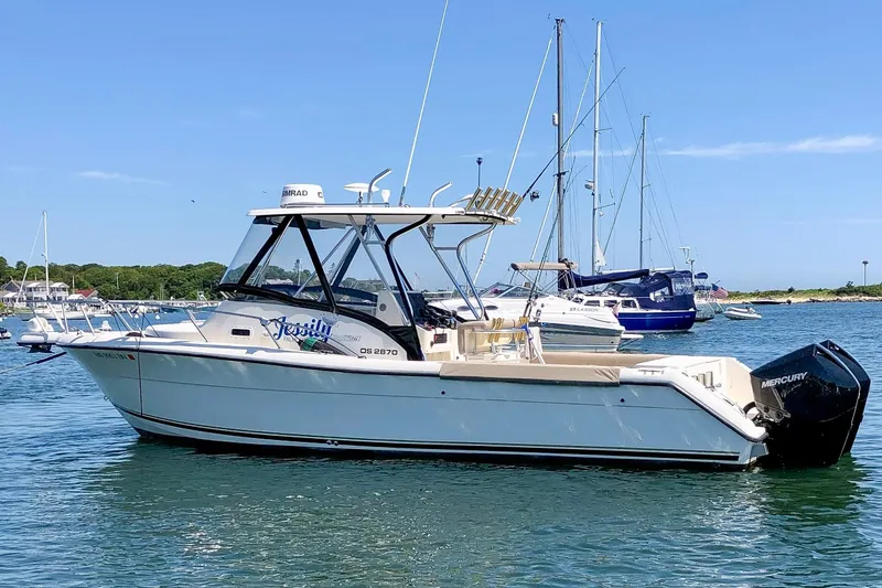 The Image of 1997 Pursuit 2870 Walkaround boat on calm water with clear blue sky. - 1
