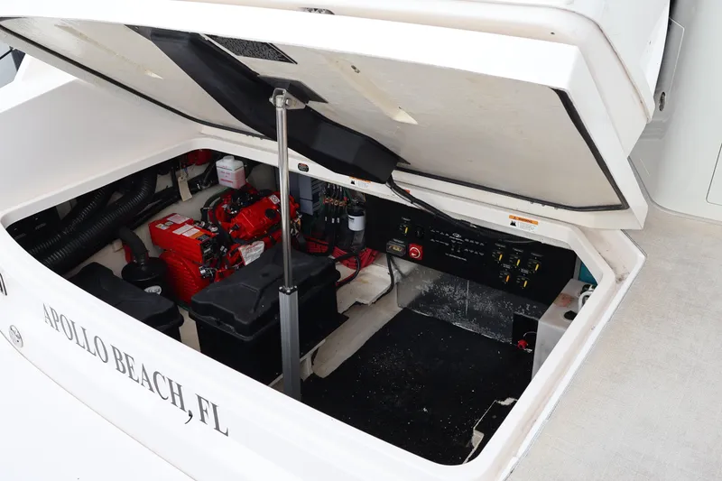 Slide: The Image of 2022 Regal 36 XO boat engine compartment, Apollo Beach, FL, showing battery and control panel. - 10