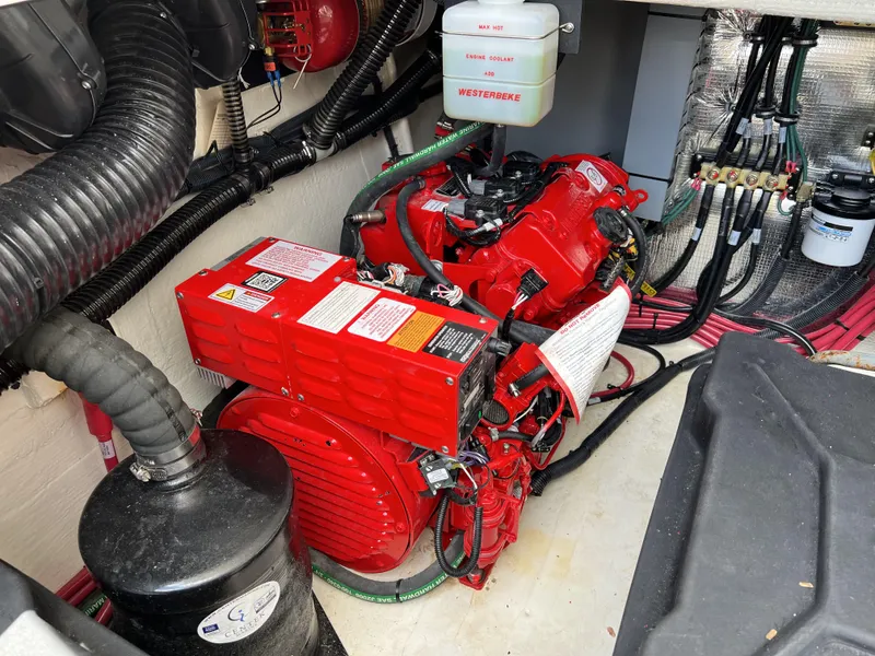 Slide: The Image of Engine compartment of a 2022 Regal 36 XO boat with red machinery. - 12