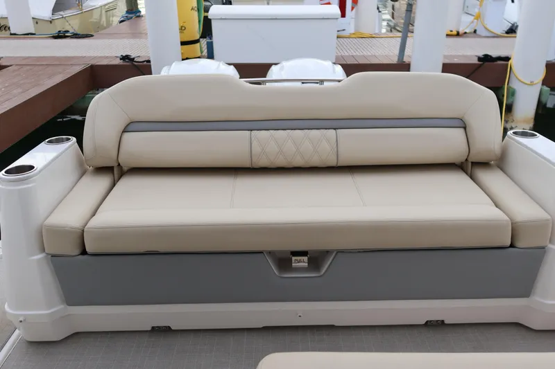 Slide: The Image of Beige seating on 2022 Regal 36 XO boat, docked with cup holders. - 15