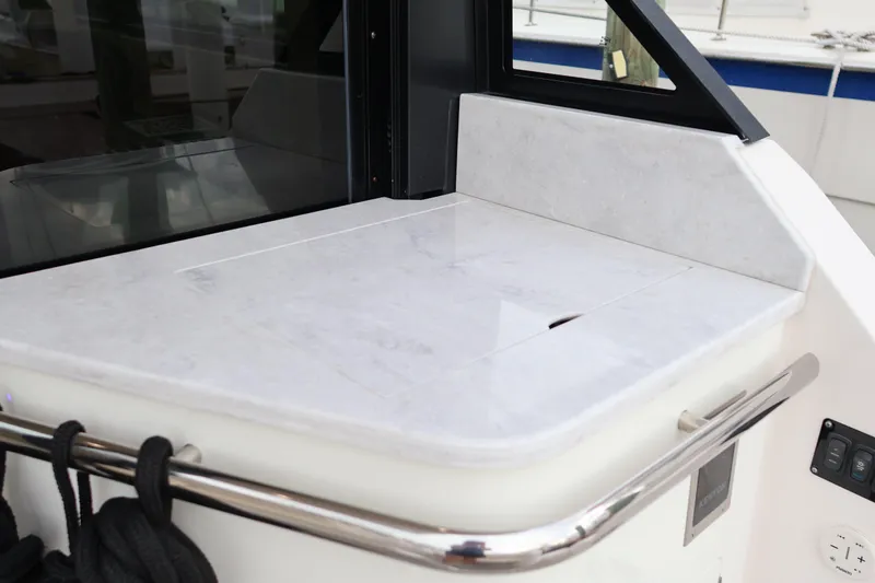 Slide: The Image of 2022 Regal 36 XO boat interior with sleek countertop and stainless steel railing. - 20