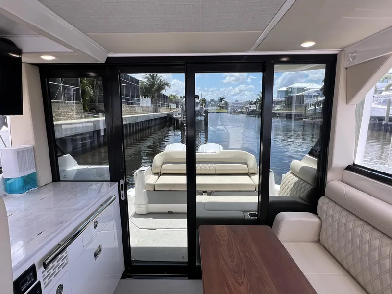 Slide: The Image of Interior view of 2022 Regal 36 XO yacht with waterfront backdrop. - 21
