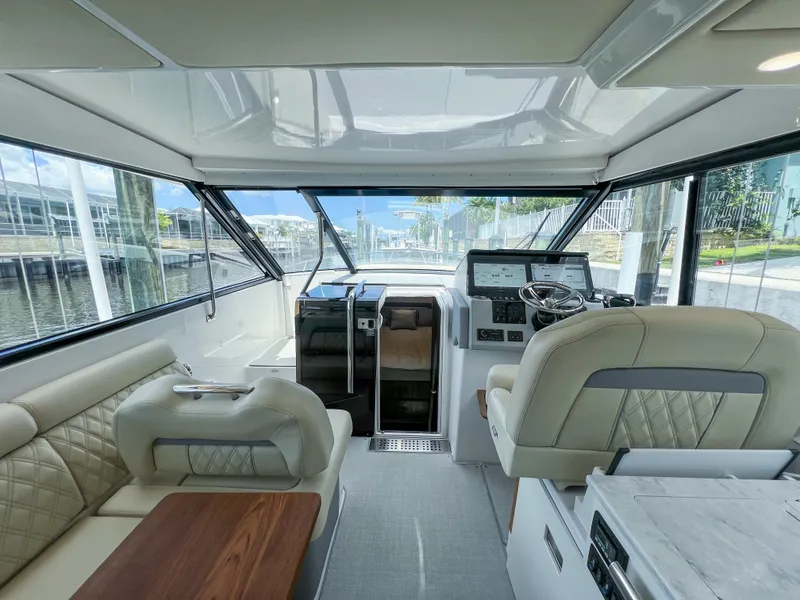 Slide: The Image of Interior of a 2022 Regal 36 XO yacht with luxurious seating and modern helm. - 24