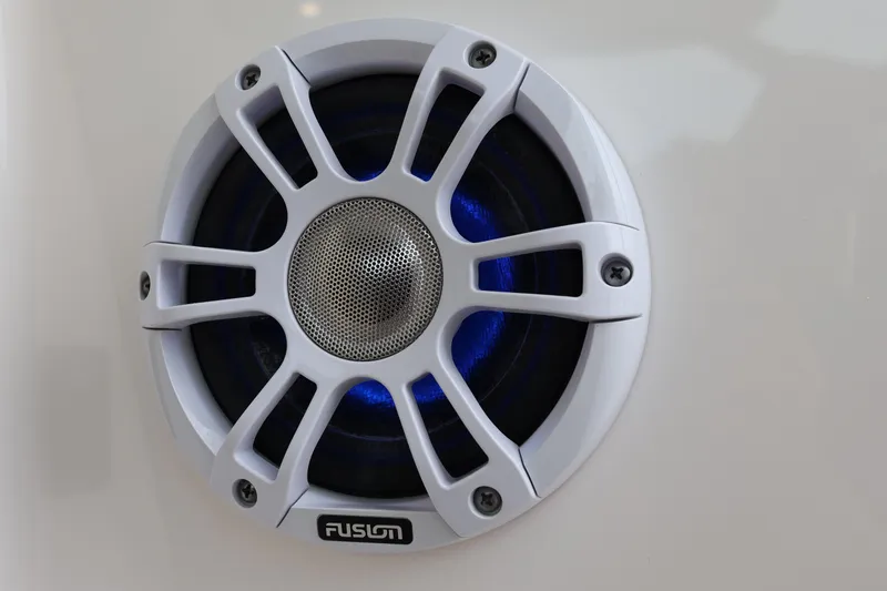 Slide: The Image of White Fusion speaker on 2022 Regal 36 XO boat, featuring blue LED lighting. - 29