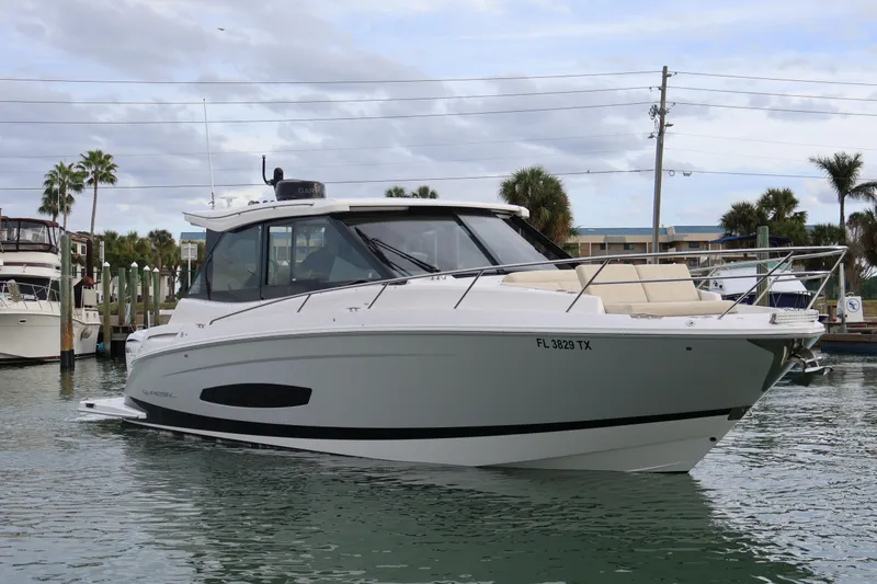 Slide: The Image of 2022 Regal 36 XO boat docked in marina, showcasing sleek design and modern features. - 3