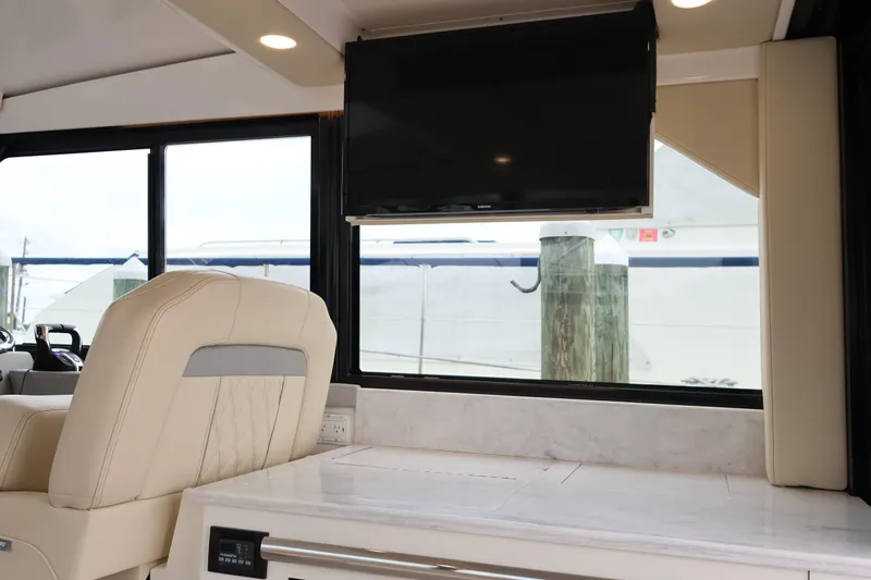 Slide: The Image of Interior of 2022 Regal 36 XO yacht with luxurious seating and mounted TV. - 31