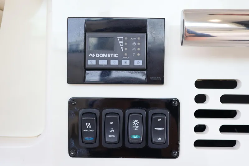 Slide: The Image of Control panel on 2022 Regal 36 XO boat featuring Dometic system and various switches. - 32