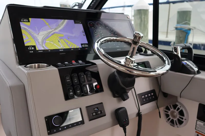 Slide: The Image of 2022 Regal 36 XO helm with navigation display and controls. - 36