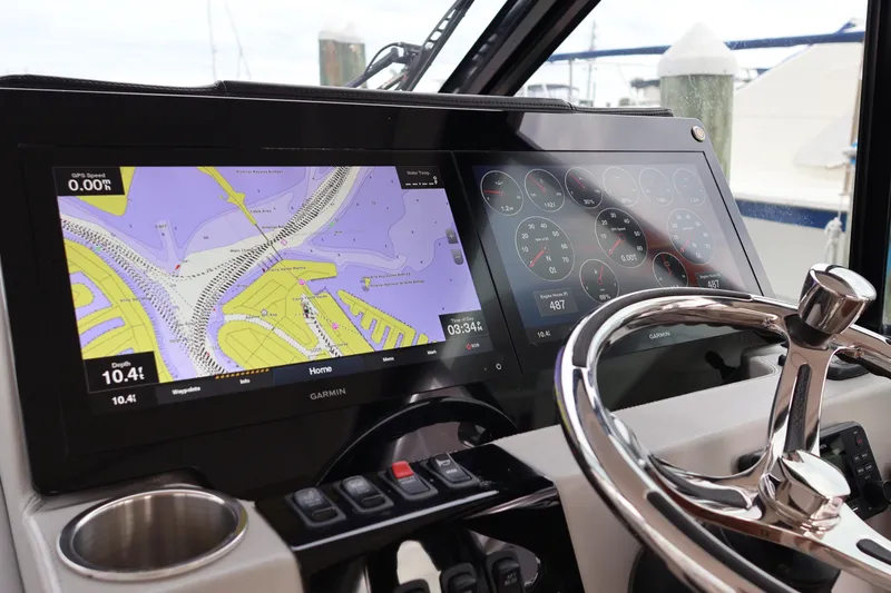 Slide: The Image of 2022 Regal 36 XO helm with dual Garmin displays and stainless steel steering wheel. - 37