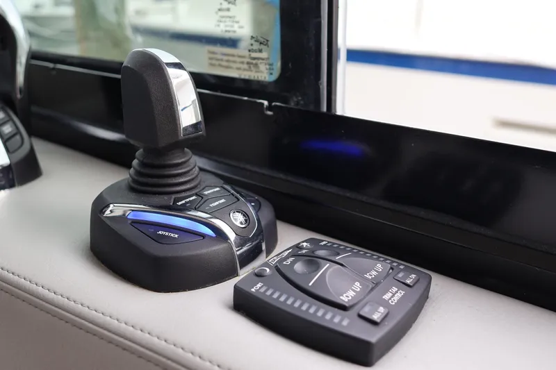 Slide: The Image of Joystick and control panel in 2022 Regal 36 XO boat cockpit. - 40