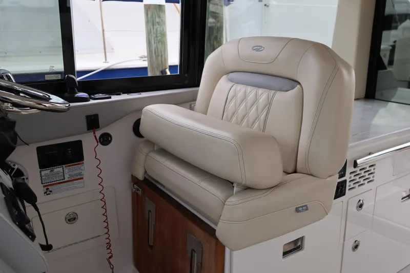Slide: The Image of Luxurious helm seat in 2022 Regal 36 XO boat, featuring elegant beige upholstery. - 42