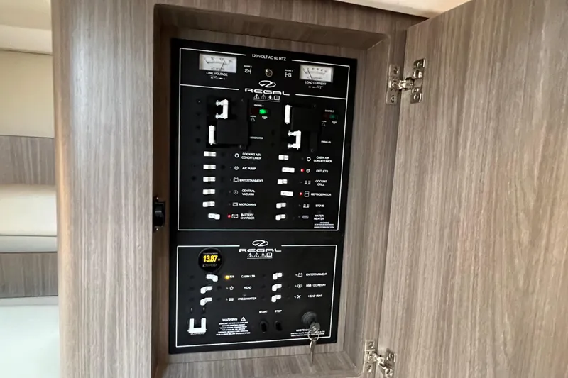 Slide: The Image of Electrical control panel of 2022 Regal 36 XO boat, featuring various switches and indicators. - 46