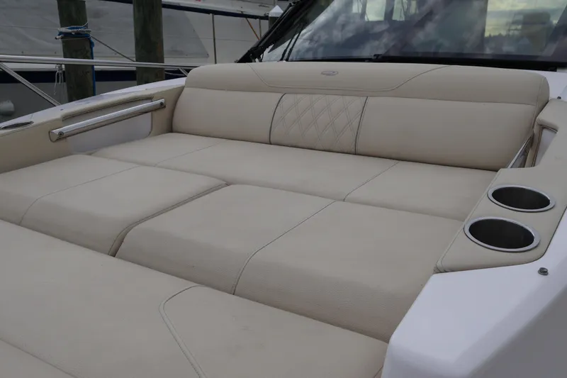 Slide: The Image of 2022 Regal 36 XO boat with luxurious beige seating and cup holders. - 55