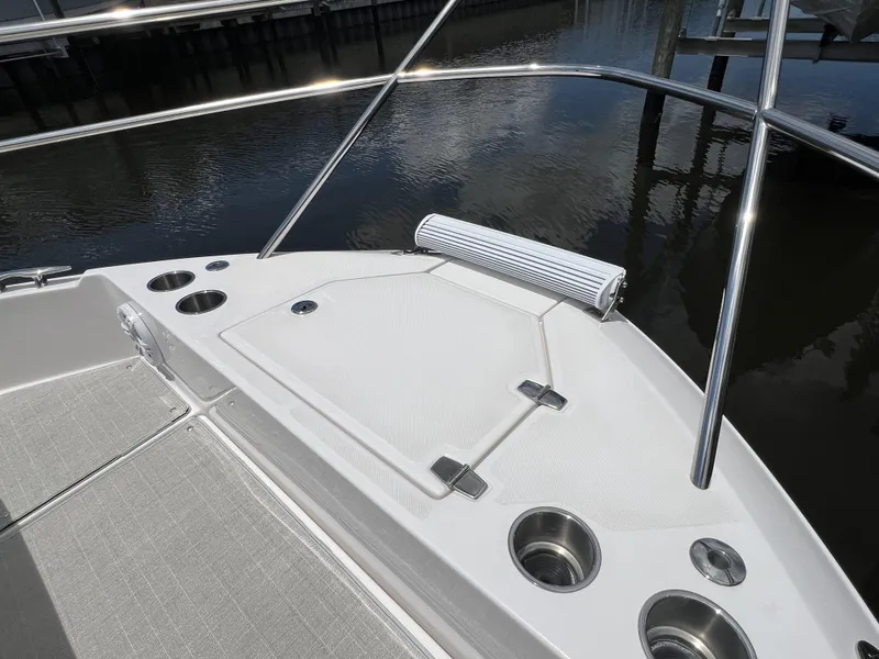 Slide: The Image of 2022 Regal 36 XO boat bow with cup holders and storage compartment. - 63