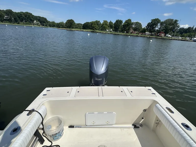 Slide: The Image of 2008 Parker 2310 Walkaround boat on calm water with outboard motor. - 10