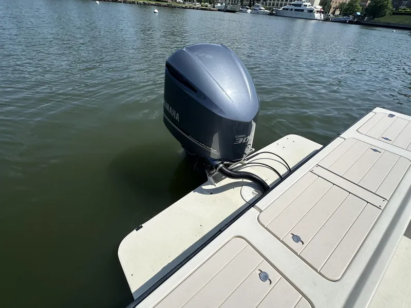 Slide: The Image of Outboard motor on a 2008 Parker 2310 Walkaround boat docked by the water. - 11