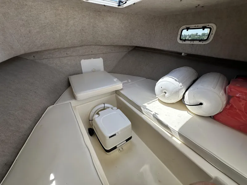Slide: The Image of 2008 Parker 2310 Walkaround cabin interior with cushions and marine equipment. - 20