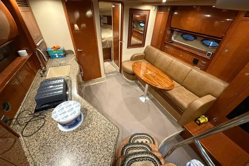 Slide: The Image of Luxurious interior of 2005 Sea Ray 390 Sundancer yacht with kitchen and seating area. - 11