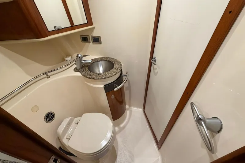 Slide: The Image of Compact bathroom in 2005 Sea Ray 390 Sundancer yacht with sink and toilet. - 17