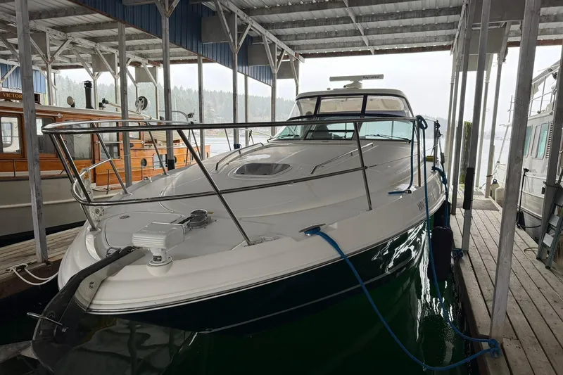 Slide: The Image of 2005 Sea Ray 390 Sundancer docked in a covered marina, side view. - 2
