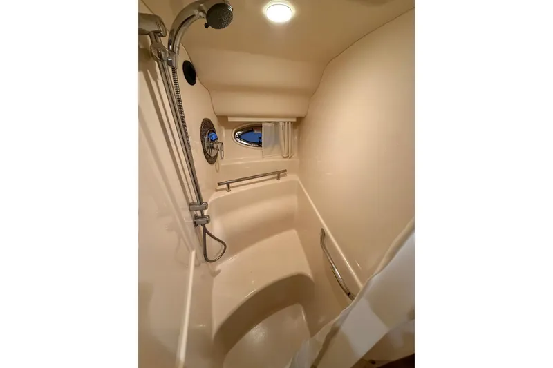 Slide: The Image of 2005 Sea Ray 390 Sundancer shower interior with modern fixtures and lighting. - 20