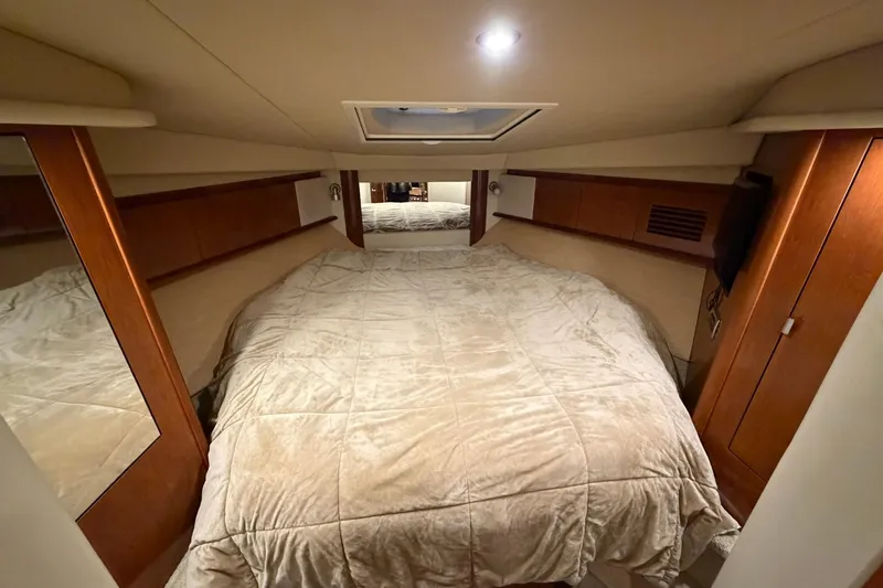 Slide: The Image of Luxurious cabin interior of 2005 Sea Ray 390 Sundancer yacht with cozy bedding. - 21