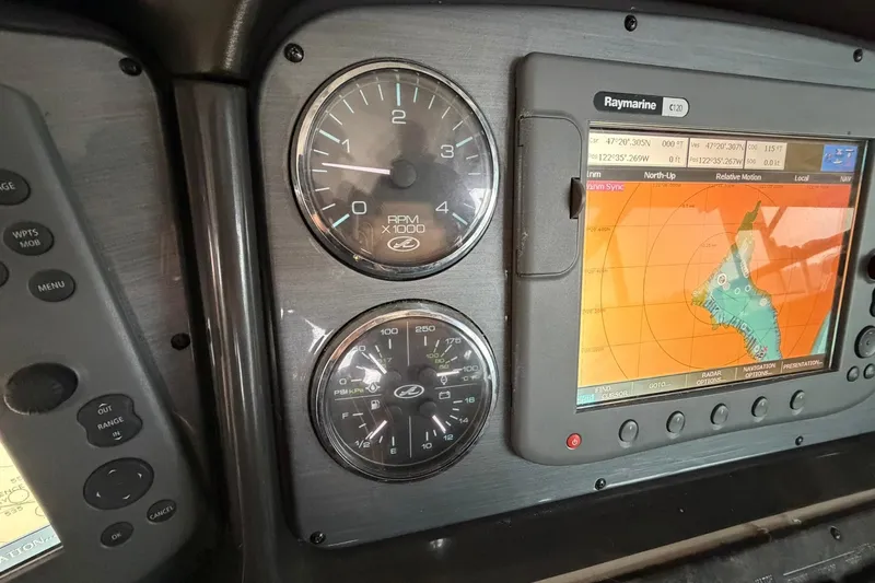 Slide: The Image of Dashboard of a 2005 Sea Ray 390 Sundancer with navigation and RPM gauges. - 23