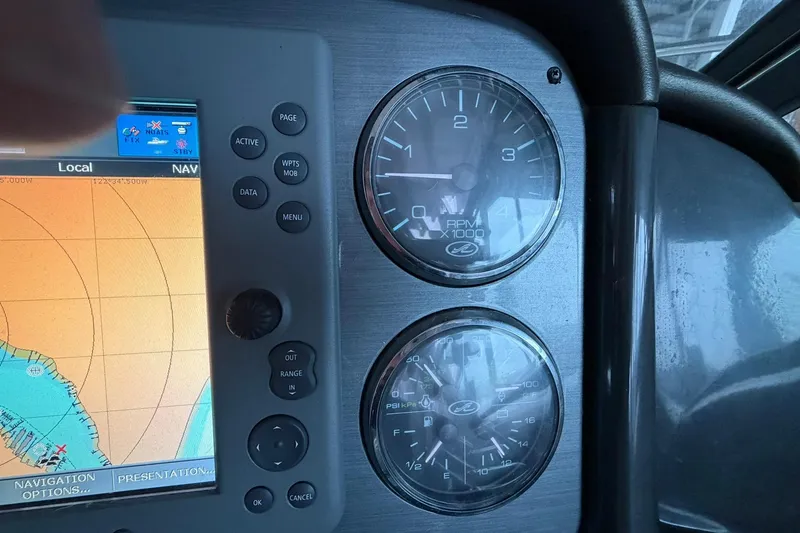 Slide: The Image of Control panel of a 2005 Sea Ray 390 Sundancer with navigation display and gauges. - 24