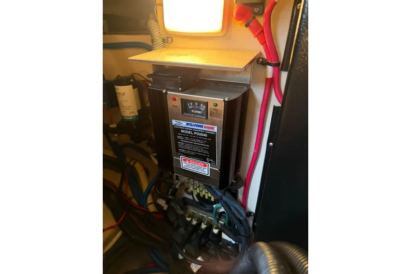Slide: The Image of Electrical panel inside a 2005 Sea Ray 390 Sundancer boat, featuring wiring and components. - 28