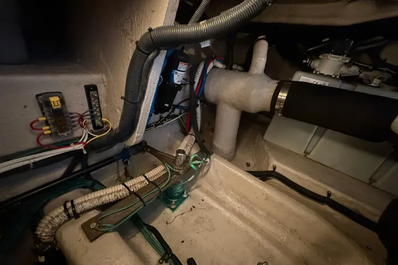 Slide: The Image of Engine compartment of a 2005 Sea Ray 390 Sundancer with visible wiring and components. - 35