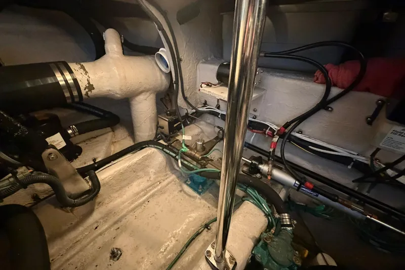 Slide: The Image of Engine room of a 2005 Sea Ray 390 Sundancer with visible pipes and wiring. - 36
